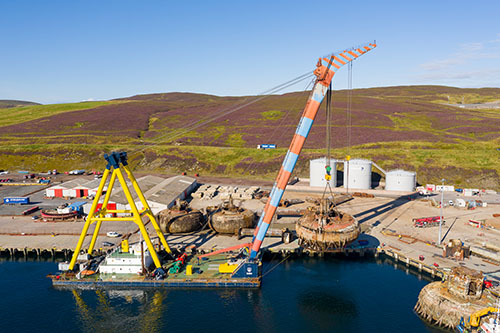 Shearleg crane Hebo 9 lifts a Buchan Alpha pontoon at Greenhead Base